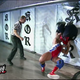 Kurt Angle — with a broken tailbone — suplexes Shane McMahon through a pane of glass.